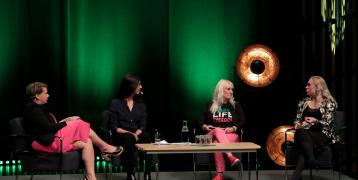 Women sitting in Panel discussion.